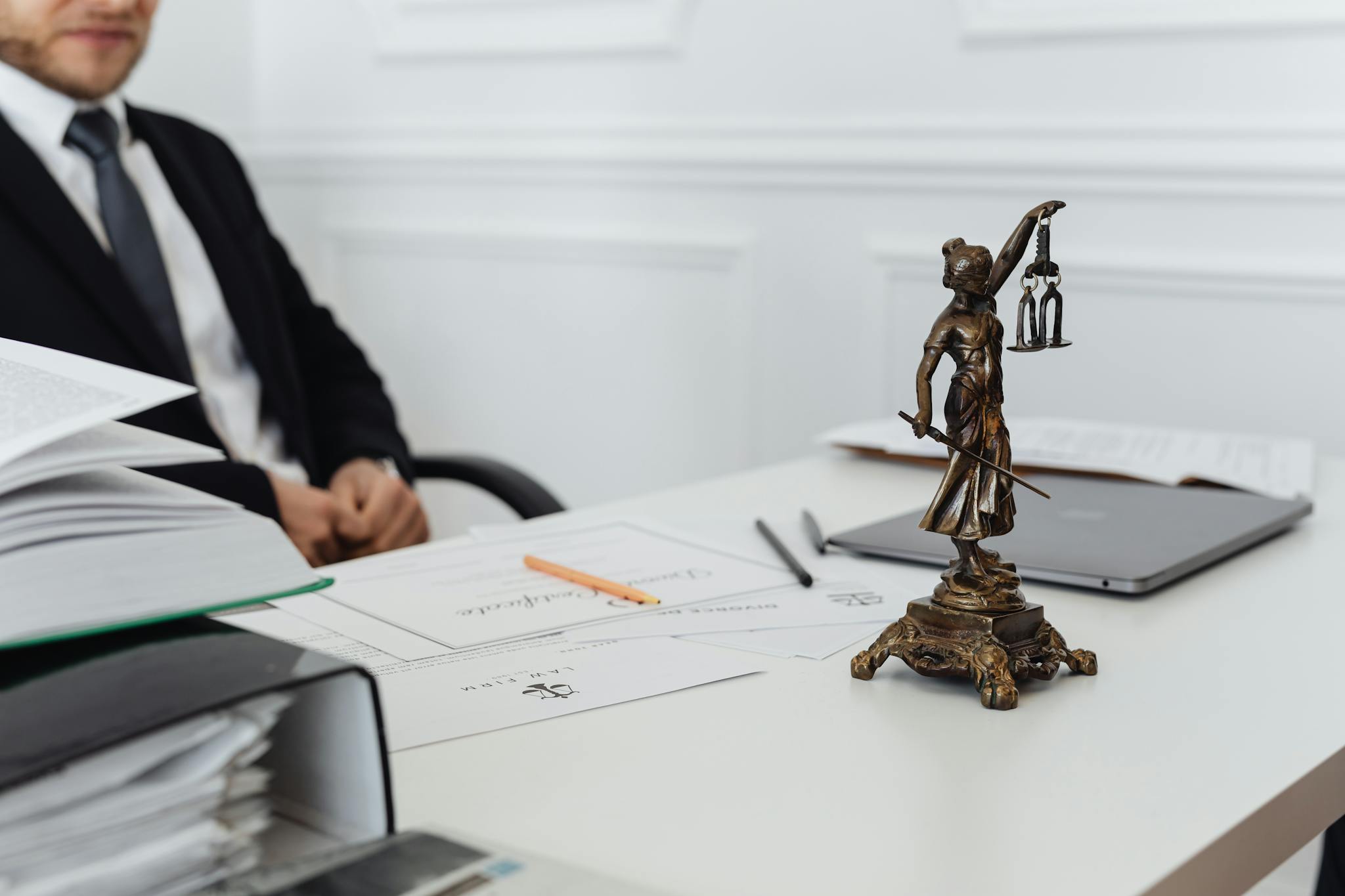 a legal professionals workspace featuring lady justice