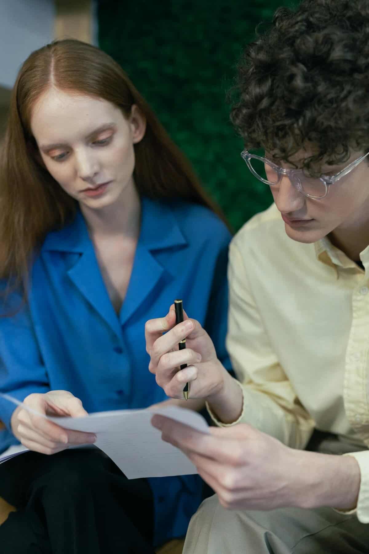 two professionals discussing and analyzing paperwork in